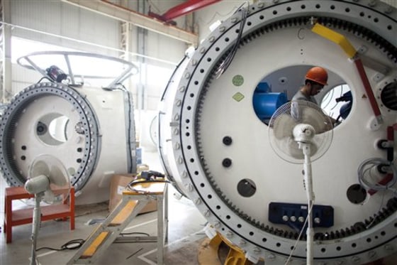 A worker assembles part of a wind turbine at a factory in Baoding, China, on Tuesday.